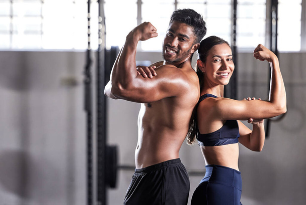 Fitness, flexing muscles and strong couple goals while doing exercise or training in a gym. Portrait of fit sports people, woman or man showing off their biceps after exercising for arm strength. - Photo, Image