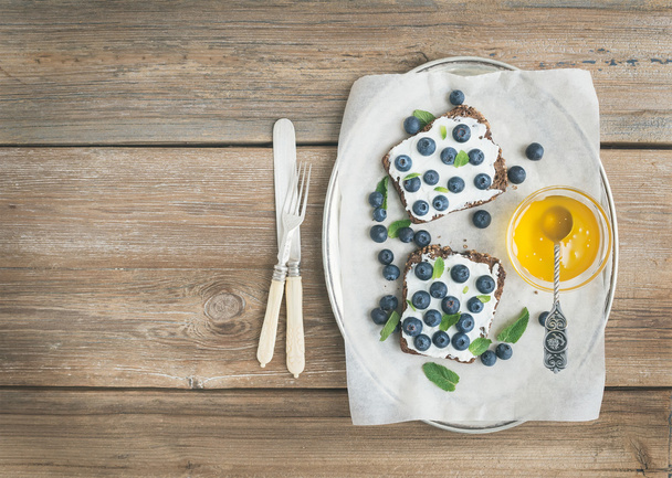 Healthy breakfast set with ricotta, fresh blueberries, honey and - Photo, image