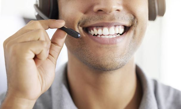 . Friednly call center, customer support or contact us employee working at telemarketing company. Closeup of happy crm worker or receptionist talking in headset in agency office - Photo, image