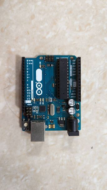Arduino Uno microcontroller board with components and specifications isolated in a plain background - Fotografie, Obrázek