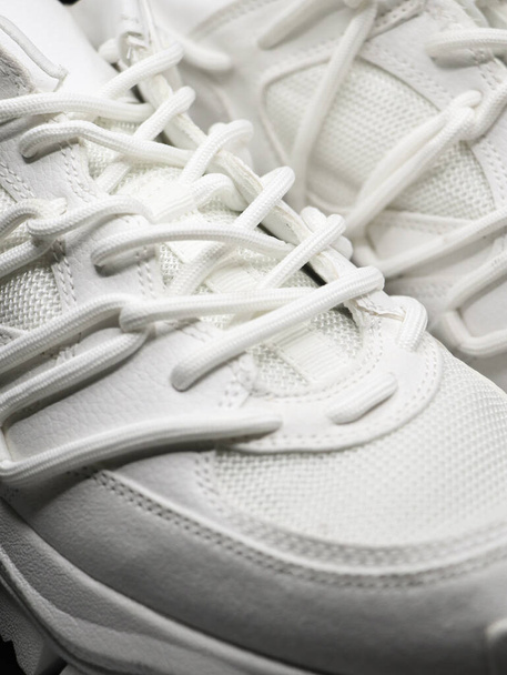 closeup isolated shot of white running shoes with white laces and nice stitching - Foto, Bild