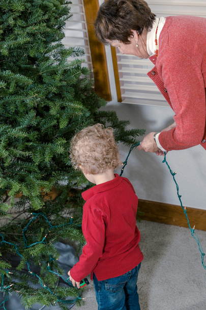 Grandmother and grandson decorating Christmas tree - Photo, Image