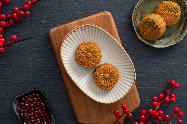 Delicious Cantonese moon cake for Mid-Autumn Festival food mooncake on blue table background for afternoon tea, holiday celebration serving. - Valokuva, kuva