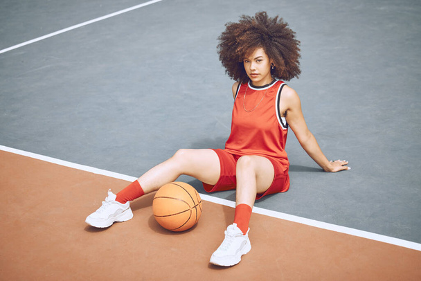 Basketball player on court, getting ready for game and workout before fitness exercise outside. Portrait of a black woman sports person with afro playing, training and exercising in sport fashion. - Foto, imagen