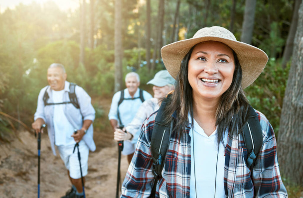 . Hiking, adventure and exploring with a senior woman and her retired friends on a hike outdoors in nature. Enjoying a walk or journey of discover in the forest or woods for leisure and recreation - 写真・画像