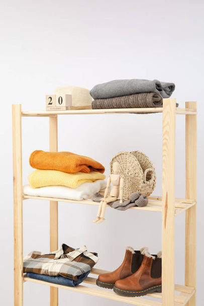 Wooden shelving with clothes, autumn season clothes - Foto, immagini