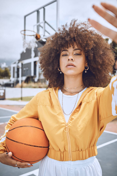 Female basketball player taking selfie on court, looking confident and training for fitness outside. Portrait of a black woman playing a game for exercise, enjoying sports competition and workout. - Photo, Image