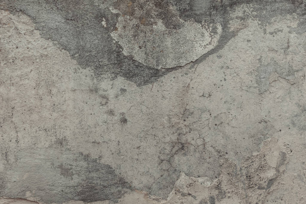 A concrete wall texture with cracks and scratches. Old cement wall, abstract grunge background. Minimal urban photo in warm beige palette. Easily add depth and organic texture to your designs. - Zdjęcie, obraz