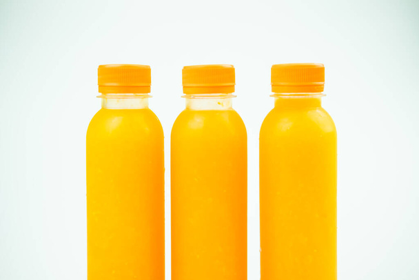 Three small bottles with orange juice. Close up - Foto, immagini