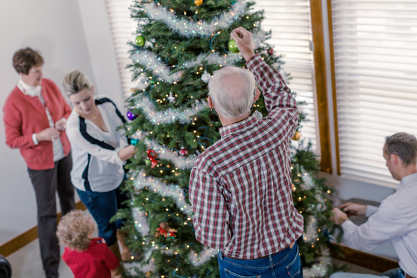 Family decorating Christmas tree - Foto, Imagem