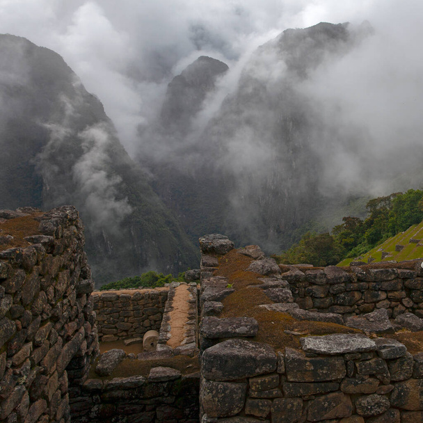 Machu Picchu ancient city view from Huchu'y Picchu in cloudy weather - Zdjęcie, obraz