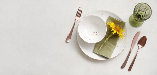 Beautiful table setting with fresh sunflower on white background with space for text, top view - Foto, imagen