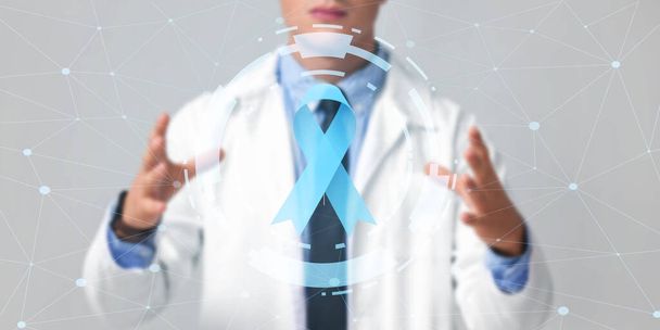 Doctor and blue ribbon on virtual screen against light background. Prostate cancer awareness concept - Photo, image