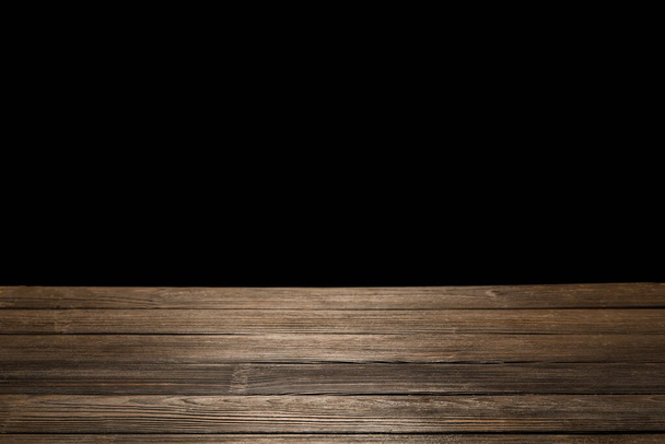 Wooden table top on black background - Foto, afbeelding