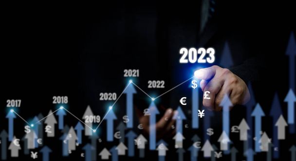 Businessman touch arrow and 2023 currency copy space background.Business finance growth success process investment economic market concept. - Photo, Image