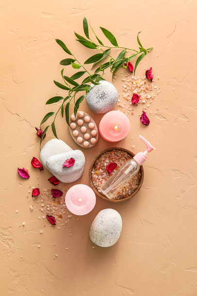 Beautiful spa composition with burning candles and flower petals on color background - Фото, изображение
