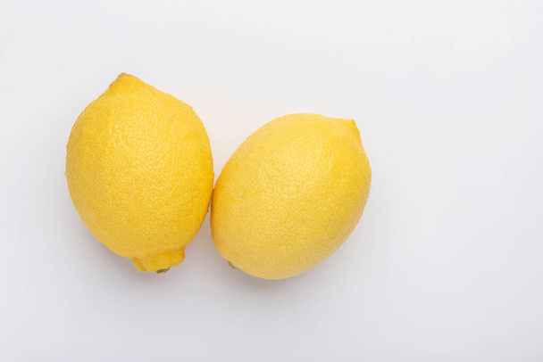 Two lemon isolated on the white backgrounds - Fotoğraf, Görsel