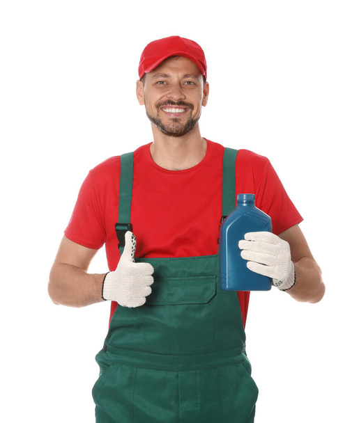 Man holding blue container and showing thumbs up of motor oil on white background - Fotografie, Obrázek