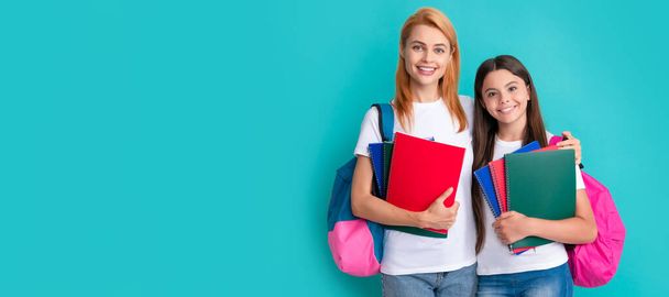 Mother and daughter child banner, copy space, isolated background. cheerful mother and daughter hold notebook and backpack ready to study, learning - Fotoğraf, Görsel