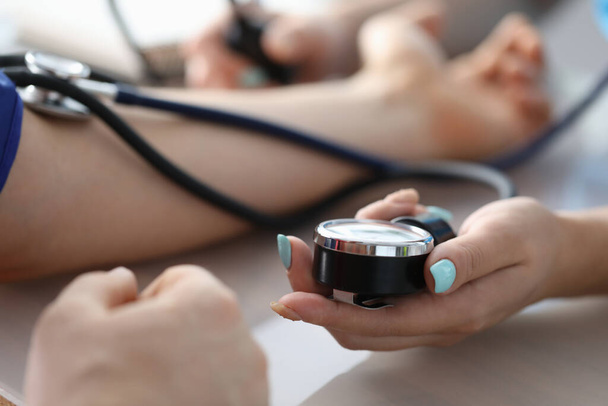 Female doctor hands male patient blood pressure measurement. Heart rate monitoring help cardiotherapist concept - Foto, Bild