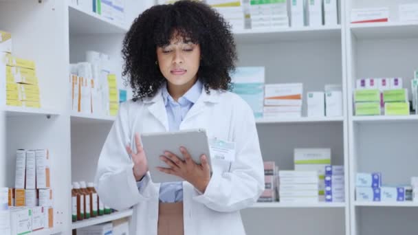 Smiling, professional healthcare pharmacist, reading and analysing medical data records on digital tablet in modern pharmacy store. Female doctor trusted with working on medicine treatment inventory. - Imágenes, Vídeo