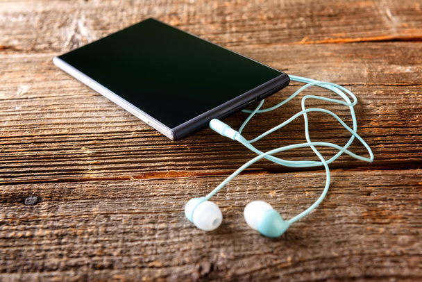 Small headphones with mobile phone - Photo, Image