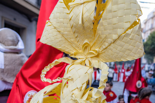 Detail of a Palm made in Elche, Spain, carried by a Nazarene and penitent, in Palm Sunday, during Holy Week, in the La Borriquita procession  - Foto, Imagem