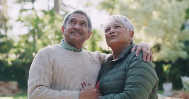Happy, smiling and mature couple in retirement, bonding and enjoying the outdoors and relaxing together in nature. Romantic, loving and mature husband and wife in love and hugging in summer outside. - Filmmaterial, Video