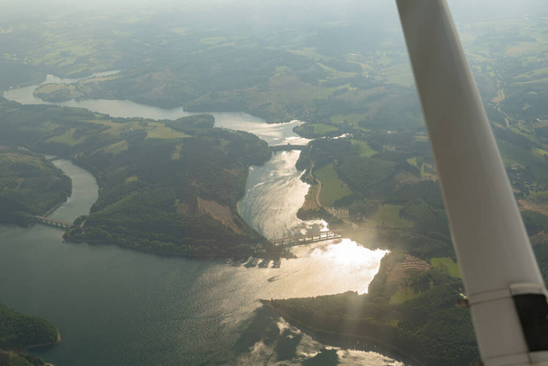 Olpe, North rhine Westphalia, Germany, July 8, 2022 Flight overhead the lake Biggesee with a small plane - Foto, Imagen