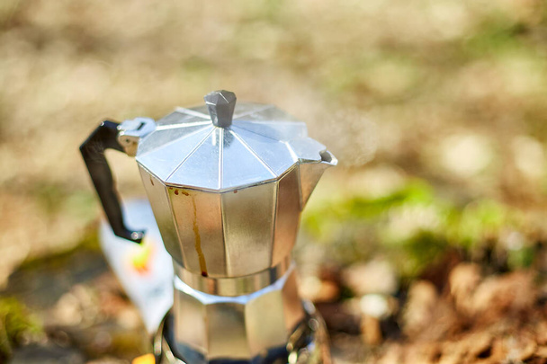 Making camping coffee from a geyser coffee maker on a gas burner,, autumn outdoor. Male prepares coffee outdoors, travel activity for relaxing, bushcraft, adventure, travel, tourism and camping concept - Fotoğraf, Görsel