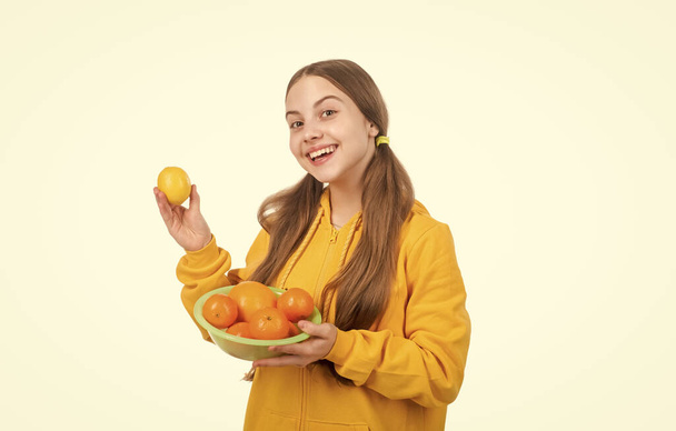 nice smile. healthy life. diet and kid skin beauty. happy teen girl with citrus fruit plate. vitamin and dieting. child eating healthy food. childhood health. citrus fruits. natural organic and fresh. - Fotó, kép