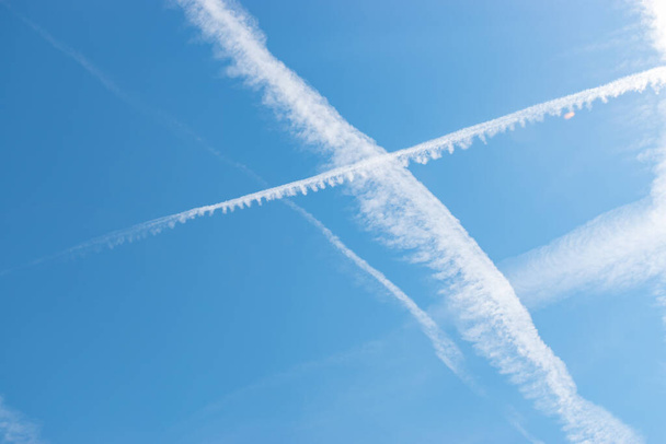 Switzerland, May 11, 2022 Contrails formation on a sunny day in spring time - Foto, Bild