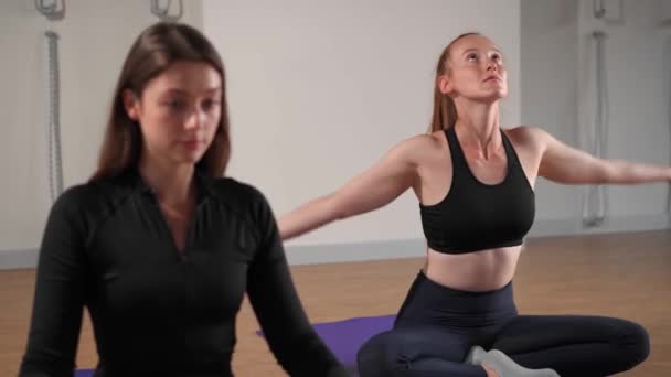 Athletic woman doing yoga for health. The girl is in the lotus position and folds her hands Namaste - Filmati, video