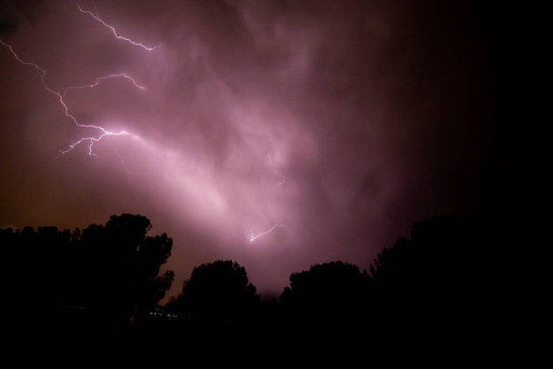 lightning storm, summer storm, lightning and thunder in purple colors - Foto, afbeelding