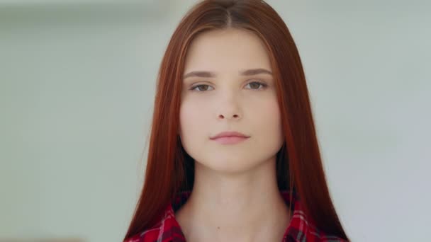 Female serious female 20s portrait indoor alone sad calm confident caucasian european appearance redhead woman student girl model with strong dark eyesight looking at camera bullying feminism equality - Materiał filmowy, wideo