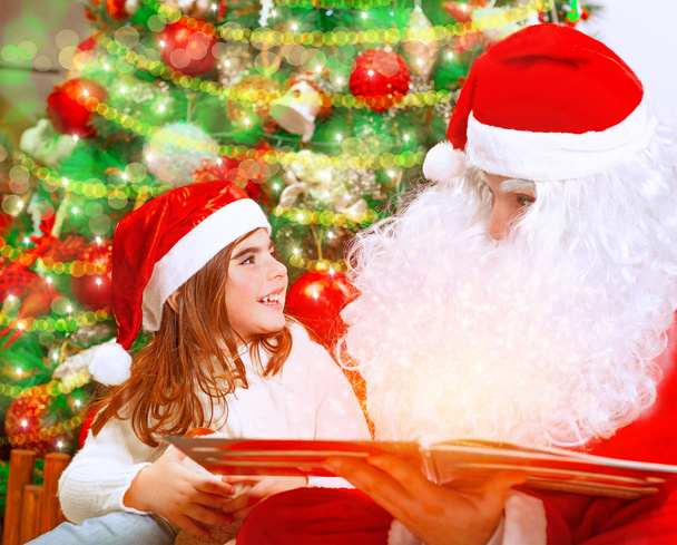Reading magic book with Santa Claus - Zdjęcie, obraz