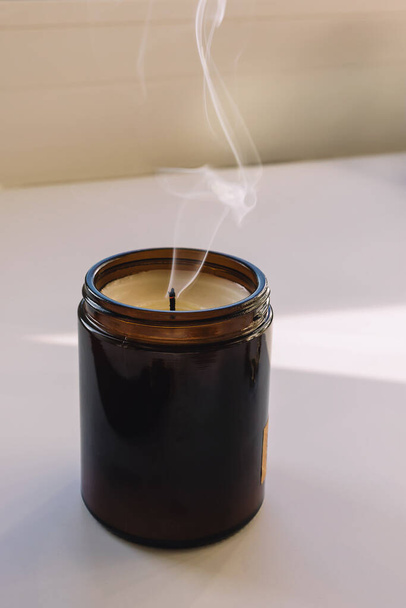 Glass candle with smoke close-up, minimalist lifestyle - 写真・画像