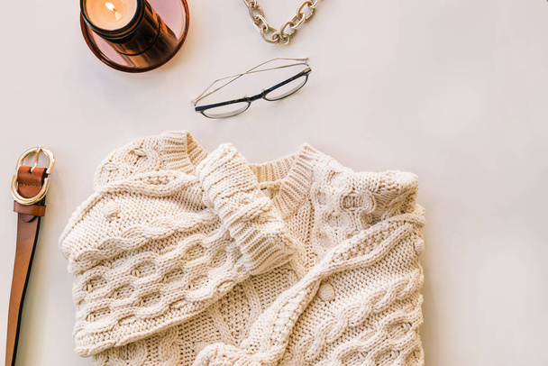 White knitted sweater, candle and glasses. Winter flat lay - Foto, Imagen