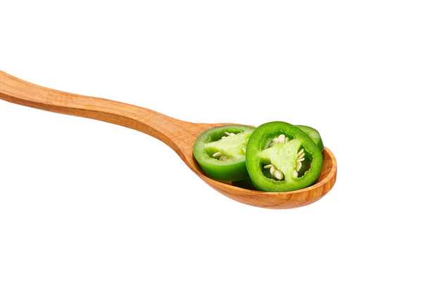 sliced jalapeno pepper in wooden spoon isolated on white background, close-up. - Foto, imagen