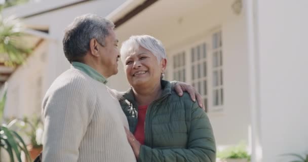 Loving, happy and joyful mature or old lovers with a retirement investment in property. New house, home loan or bank loan approved for a senior couple standing outside their home on a weekend - Video