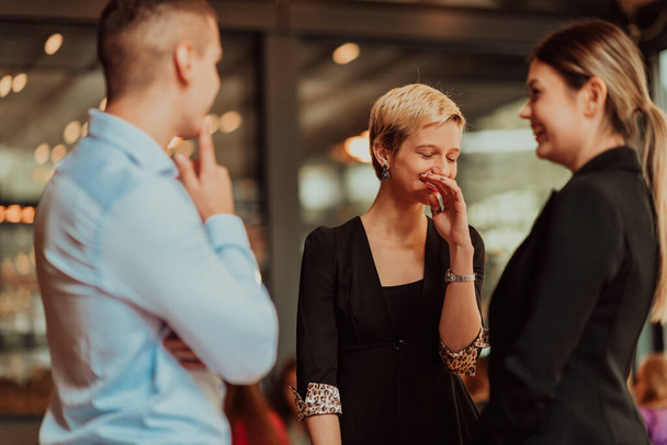 Photo of a business team of young people discussing business ideas in a modern urban environment. Selective focus. High quality photo - Foto, imagen