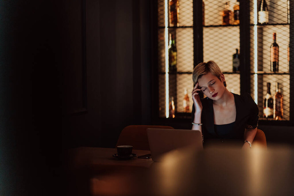 Businesswomen are stressed while working on laptops, Tired businesswomen with headaches in a coffee shop, and feeling sick at work. Selective focus. High quality photo - 写真・画像