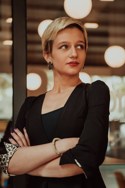 Businesswoman in a black suit, successful confidence with arms crossed in modern office. Selective focus. High quality photo - Foto, Imagen