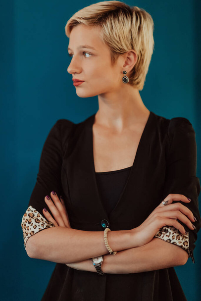 Pretty business woman, successful confidence with arms crossed on modern blue mat background. Selective focus. High quality photo - Valokuva, kuva