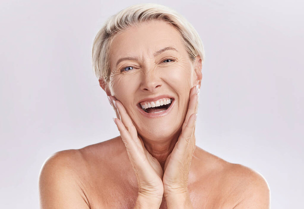 Botox, menopause and anti aging woman in beauty, skincare or face wash portrait in a studio. Plastic surgery, dermatology or cosmetics senior model with a smile touching her natural looking skin. - Photo, image