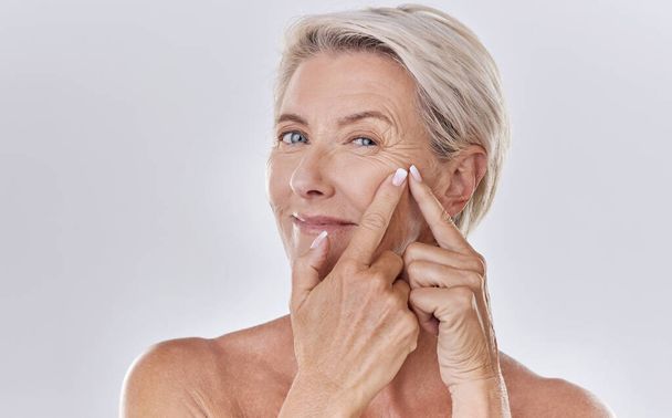 Acne or pimple popping female or woman after night face skincare beauty treatment for healthy and clear skin copy space. Portrait of happy senior woman use cosmetics with hands to target wrinkles. - Fotografie, Obrázek