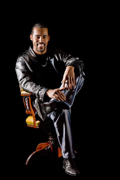 Portrait of cool latino man on black - Фото, изображение