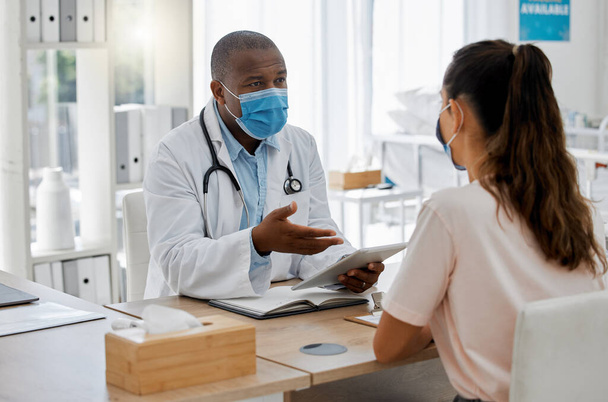 Doctors office, masks and sick patient consulting healthcare medic for covid virus test results at a hospital desk. Life insurance, people and medical employee giving woman support, help and service. - Zdjęcie, obraz