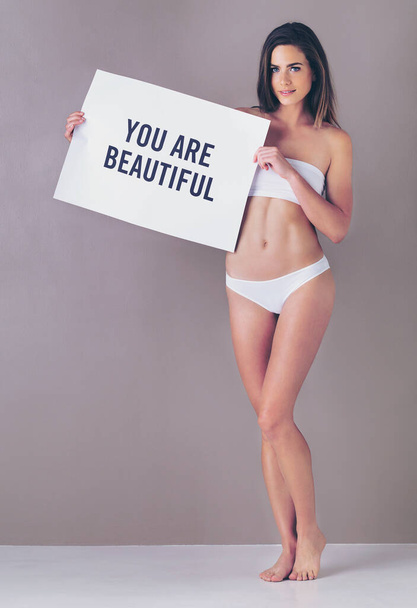 Always have been and always will be. Studio portrait of an attractive young woman holding a sign that reads you are beautiful against a pink background - Fotoğraf, Görsel