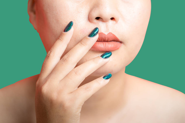 Female hand with green nail design on green background. Woman manicure is art beautiful summer style. Close-up of healthy young girl beauty fingers. - Fotó, kép